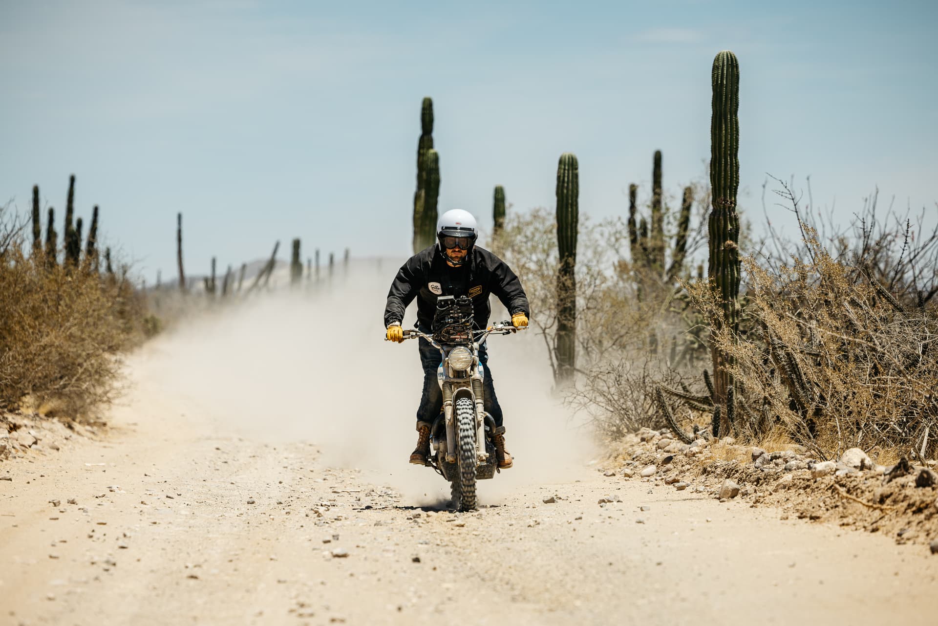 Three men on Triumph Motorcycles in the desert wearing Triumph Heritage Clothing