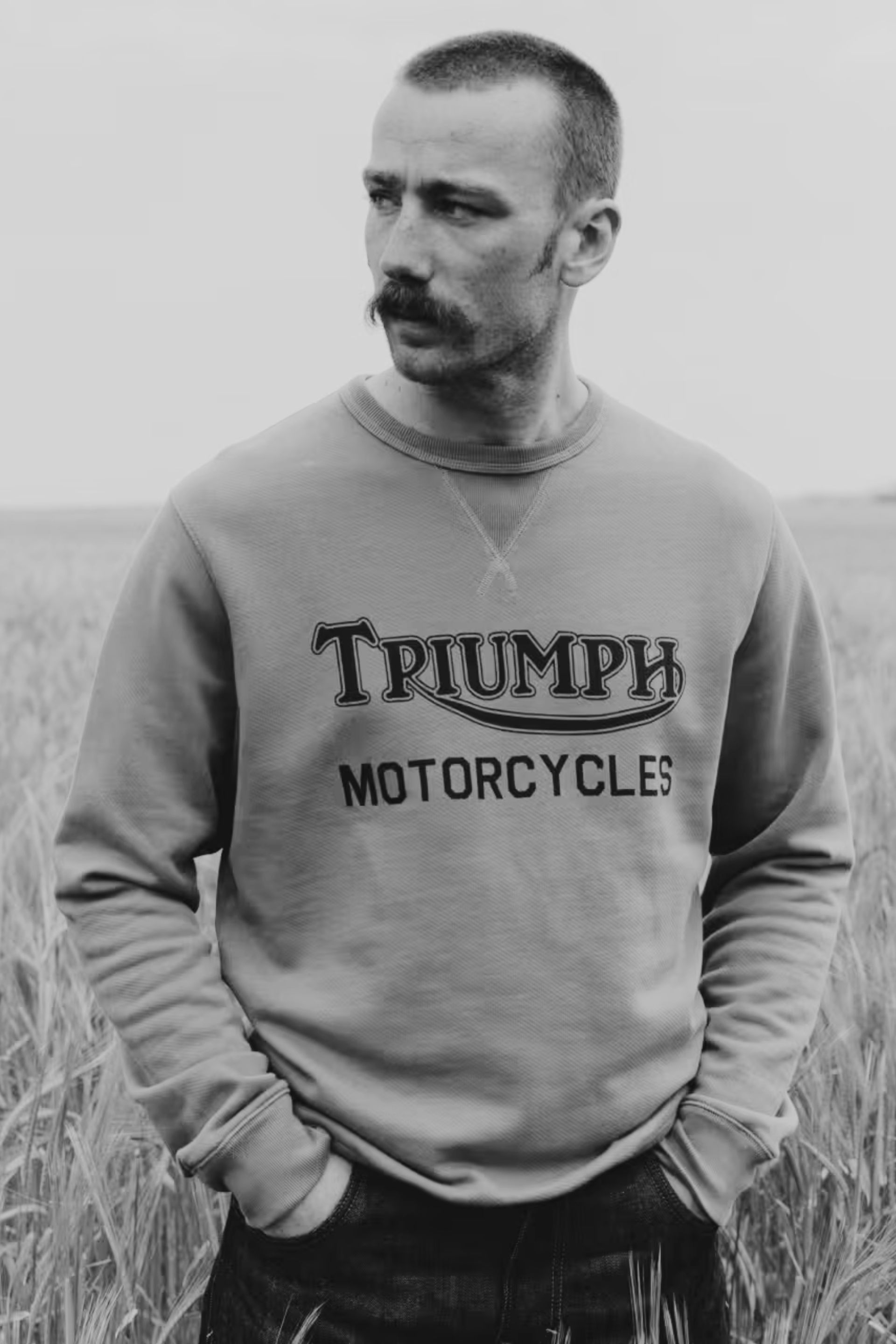 Man stood in field wearing triumph heritage